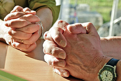 A photographic image of people praying together.