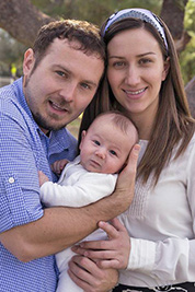 A photographic image of young parents with their baby.