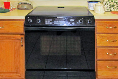 A photographic image of a black stove and oven.