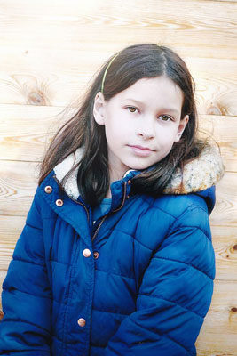 A photographic image of a young girl wearing a coat.