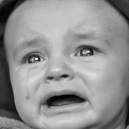 A photographic image of a crying baby.