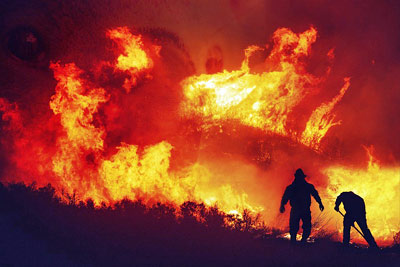 A photographic image of fire fighters battling a wildfire.